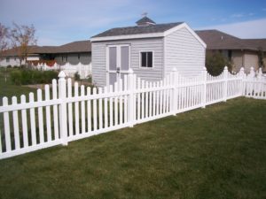 under-scalloped white picket fence. Residential fencing Cedar Rapids, Iowa fencing contractors fence company overscalloped arched picket plank vinyl wood cedar western red cedar alternating board on board cap red cedar white khaki chestnut sandstone tan UVB sun solid french scalloped 