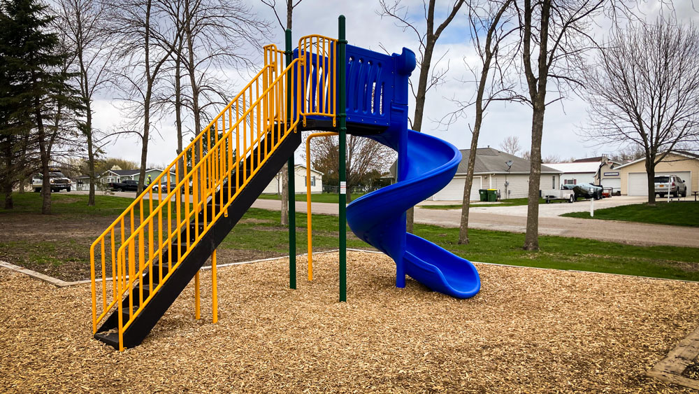 Blue slide with stairs and top platform. Playground company Cedar Rapids, Iowa playground installation playground equipment slides swings surfacing climbers children recreation safety durable