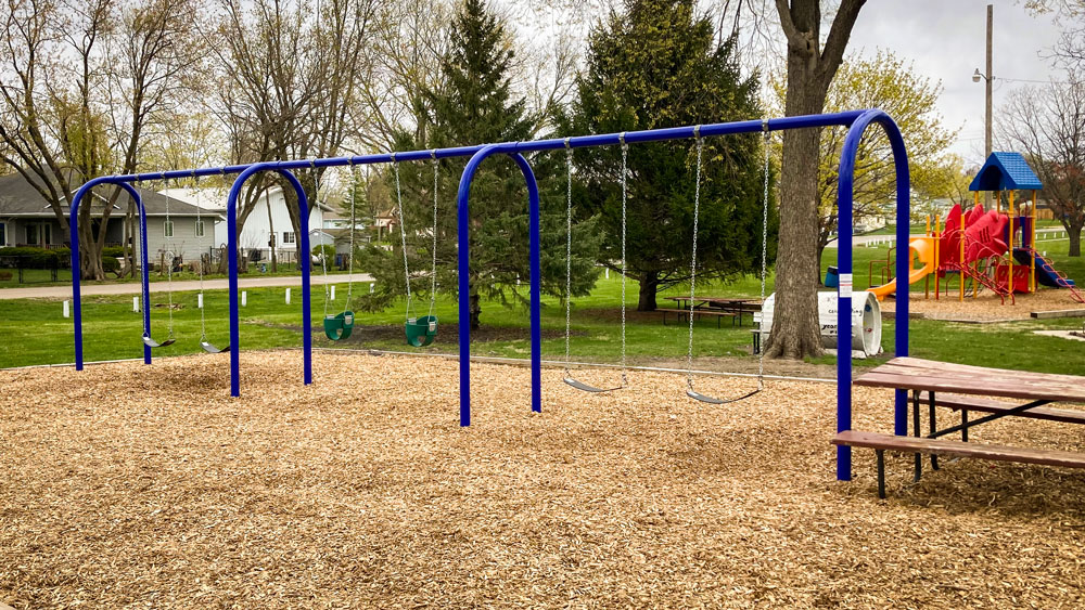 Swing set with blue metal frame for small residential park. Playground company Cedar Rapids, Iowa playground installation playground equipment slides swings surfacing climbers children recreation safety durable