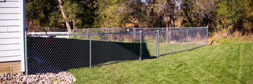 Cedar Rapids fence company chain link fence residential fencing contractors Nebraska industrial high security recreational sport ballfield tennis court basketball pickleball football high school college playground chain link gate posts tubing pipe top rail chain link fabric wire mesh galvanized aluminum vinyl coated black brown green 9 gauge fence fencing security perimeter hinges installation repair costs panels hardware fittings