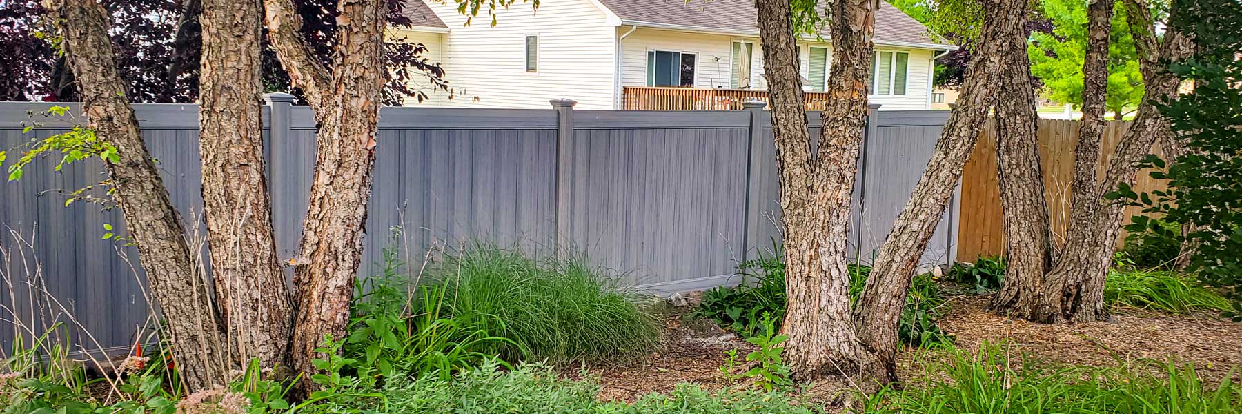 Cedar Rapids fence company residential fence contractors Iowa board on board shadow box picket alternating staggered wood vinyl tan sandstone white sandstone khaki cracking chipping splitting UVB residential backyard perimeter security visibility solid 